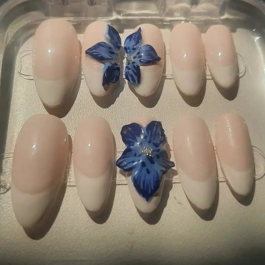 Set de 10 faux ongles nude ornés de fleurs bleues 3D sculptées avec strass dorés au centre