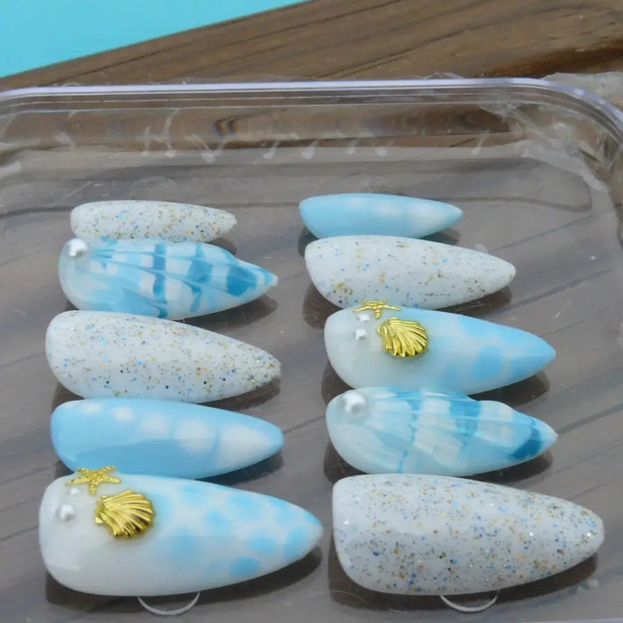 De l'eau, du sable, des coquillages, des étoiles de mer, ces faux ongles vous feront vivre une escapade au bord de la plage
